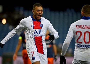 Paris Saint-Germain's French forward Kylian Mbappe (L) celebrates after scoring a goal during the French L1 football match between Montpellier Herault (MHSC) and Paris Saint Germain (PSG) at the Mosson Stadium in Montpellier, southern France, on December 05, 2020. (Photo by Pascal GUYOT / AFP)