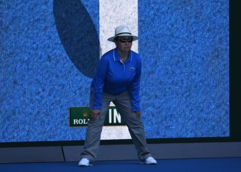 A linesperson stands in front of a screen showing a video review of a ball that was "in" during the men's singles first round match betweem Australia's Bernard Tomic and Brazil's Thomaz Bellucci on day one of the Australian Open tennis tournament in Melbourne on January 16, 2017. / AFP / WILLIAM WEST / --IMAGE RESTRICTED TO EDITORIAL USE - STRICTLY NO COMMERCIAL USE--        (Photo credit should read WILLIAM WEST/AFP via Getty Images)