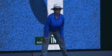 A linesperson stands in front of a screen showing a video review of a ball that was "in" during the men's singles first round match betweem Australia's Bernard Tomic and Brazil's Thomaz Bellucci on day one of the Australian Open tennis tournament in Melbourne on January 16, 2017. / AFP / WILLIAM WEST / --IMAGE RESTRICTED TO EDITORIAL USE - STRICTLY NO COMMERCIAL USE--        (Photo credit should read WILLIAM WEST/AFP via Getty Images)