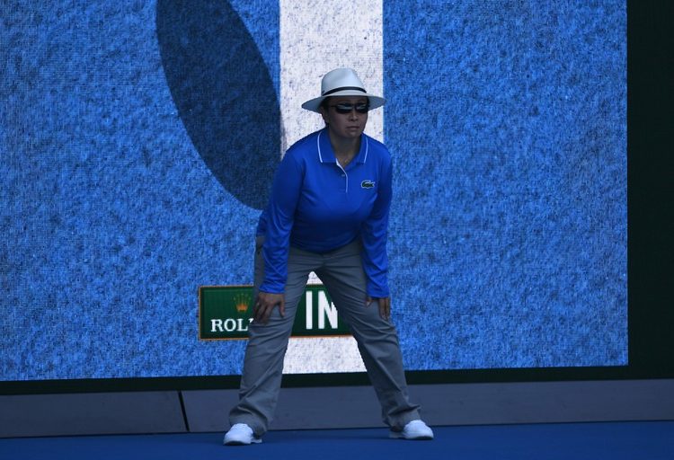 A linesperson stands in front of a screen showing a video review of a ball that was "in" during the men's singles first round match betweem Australia's Bernard Tomic and Brazil's Thomaz Bellucci on day one of the Australian Open tennis tournament in Melbourne on January 16, 2017. / AFP / WILLIAM WEST / --IMAGE RESTRICTED TO EDITORIAL USE - STRICTLY NO COMMERCIAL USE--        (Photo credit should read WILLIAM WEST/AFP via Getty Images)