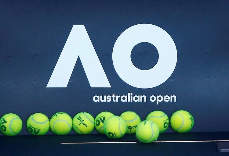 FILE PHOTO: Tennis - Australian Open - Melbourne, Australia, January 14, 2018. Tennis balls are pictured in front of the Australian Open logo before the tennis tournament. REUTERS/Thomas Peter/File Photo
