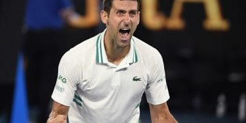 Serbia's Novak Djokovic celebrates after defeating Russia's Daniil Medvedev in the men's singles final at the Australian Open tennis championship in Melbourne, Australia, Sunday, Feb. 21, 2021.(AP Photo/Andy Brownbill)