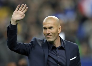 FILE - In this March 26, 2015 file photo, former soccer player and current Real Madrid B team coach Zinedine Zidane waves to spectators prior to the international friendly soccer match between France and Brazil at the Stade de France, north of Paris, France. Real Madrids President Florentino Perez announced Monday Jan. 4, 2016 that current coach Rafael Benitez has been fired and former player and Real Madrids B team coach Zinedine Zidane will take over. Benitez, hired seven months ago, has been under pressure since a demoralising 4-0 home loss to Barcelona in November. The team won seven of nine matches since the defeat at the Bernabeu, but fans continued to call for Benitez's departure. (AP Photo/Francois Mori, File)