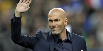 FILE - In this March 26, 2015 file photo, former soccer player and current Real Madrid B team coach Zinedine Zidane waves to spectators prior to the international friendly soccer match between France and Brazil at the Stade de France, north of Paris, France. Real Madrids President Florentino Perez announced Monday Jan. 4, 2016 that current coach Rafael Benitez has been fired and former player and Real Madrids B team coach Zinedine Zidane will take over. Benitez, hired seven months ago, has been under pressure since a demoralising 4-0 home loss to Barcelona in November. The team won seven of nine matches since the defeat at the Bernabeu, but fans continued to call for Benitez's departure. (AP Photo/Francois Mori, File)
