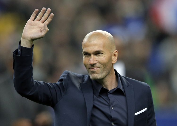 FILE - In this March 26, 2015 file photo, former soccer player and current Real Madrid B team coach Zinedine Zidane waves to spectators prior to the international friendly soccer match between France and Brazil at the Stade de France, north of Paris, France. Real Madrids President Florentino Perez announced Monday Jan. 4, 2016 that current coach Rafael Benitez has been fired and former player and Real Madrids B team coach Zinedine Zidane will take over. Benitez, hired seven months ago, has been under pressure since a demoralising 4-0 home loss to Barcelona in November. The team won seven of nine matches since the defeat at the Bernabeu, but fans continued to call for Benitez's departure. (AP Photo/Francois Mori, File)