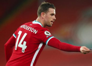 LIVERPOOL, ENGLAND - FEBRUARY 20: Jordan Henderson of Liverpool hands over the captains armband as he goes off injured during the Premier League match between Liverpool and Everton at Anfield on February 20, 2021 in Liverpool, United Kingdom. Sporting stadiums around the UK remain under strict restrictions due to the Coronavirus Pandemic as Government social distancing laws prohibit fans inside venues resulting in games being played behind closed doors. (Photo by Robbie Jay Barratt - AMA/Getty Images)