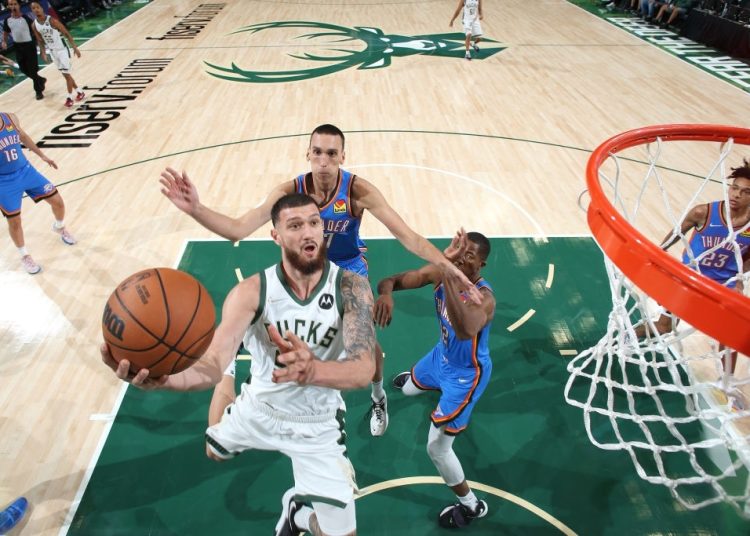 MILWAUKEE, WI - OCTOBER 10: Sandro Mamukelashvili #54 of the Milwaukee Bucks shoots the ball against the Oklahoma City Thunder during a preseason game on October 10, 2021 at the Fiserv Forum Center in Milwaukee, Wisconsin. NOTE TO USER: User expressly acknowledges and agrees that, by downloading and or using this Photograph, user is consenting to the terms and conditions of the Getty Images License Agreement. Mandatory Copyright Notice: Copyright 2021 NBAE (Photo by Gary Dineen/NBAE via Getty Images).